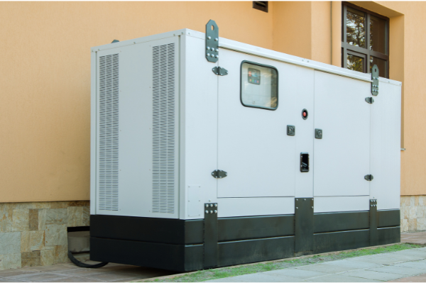 A commercial generator outside connected to a building.